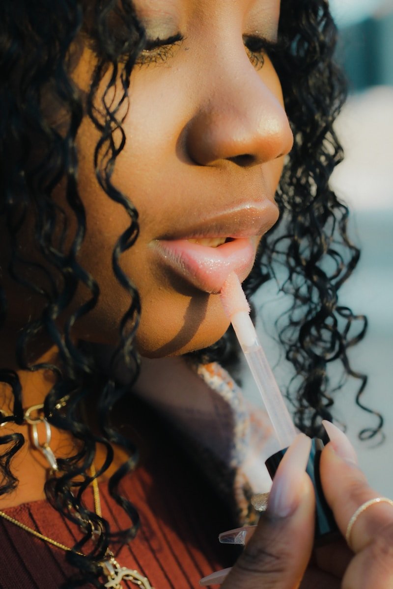 Photo by Peter Kalonji a close up of a person holding a toothbrush