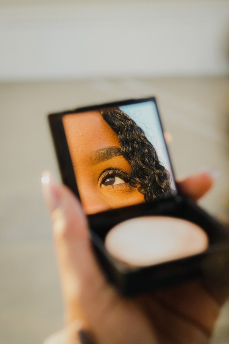 Photo by Peter Kalonji a woman holding a compact compact compact compact compact compact compact compact compact compact compact compact